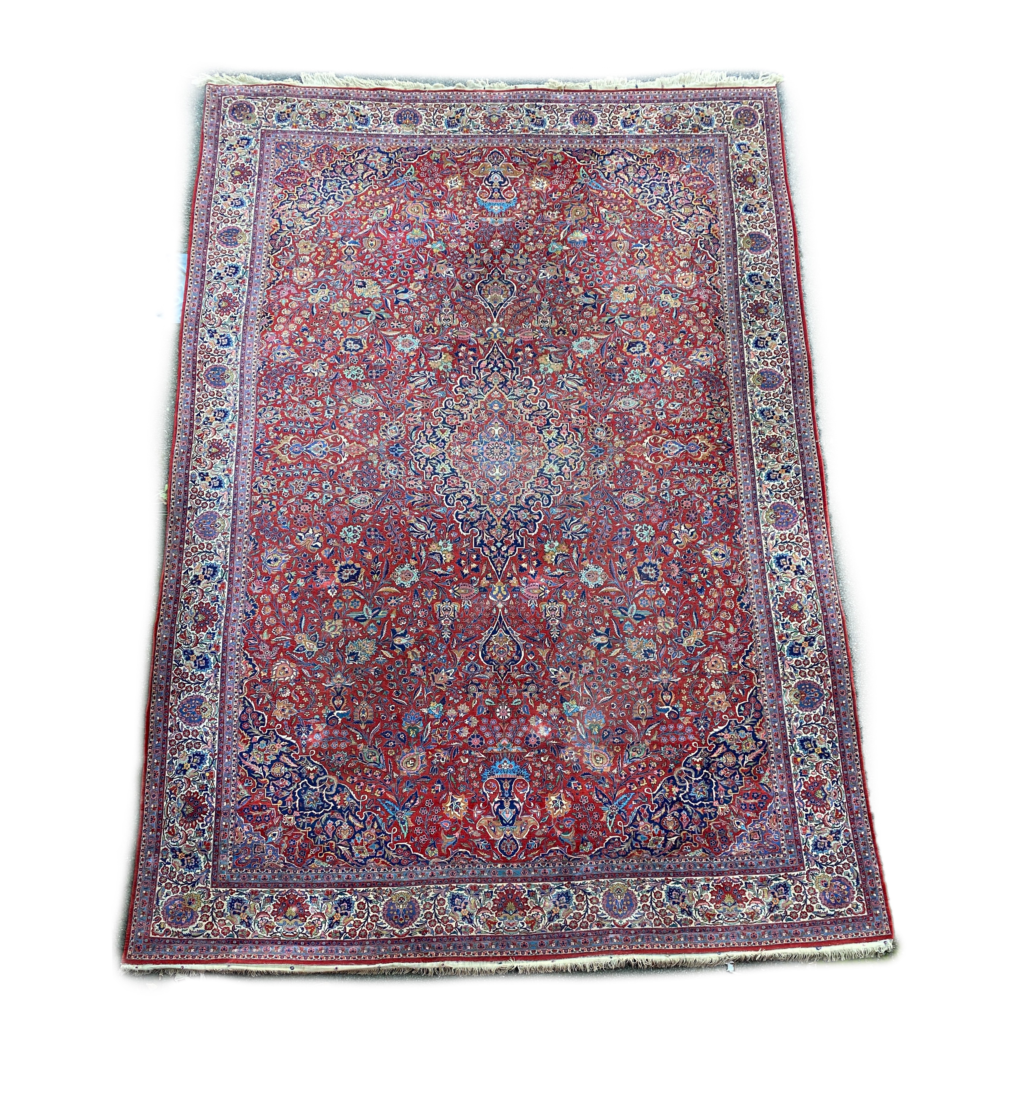 A Tabriz red ground carpet with, first half 20th century, 510cm x 355cm